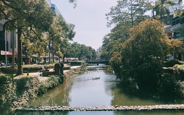 Trees leaning over the old Hsinchu city moat, with a path along the bank