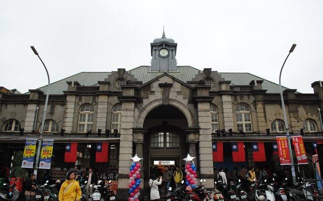The ornate stone front of Hsinchu Railway Station with its clock tower